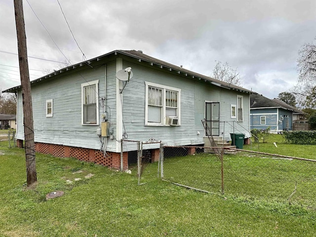 back of house with a lawn