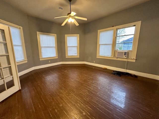 empty room featuring dark hardwood / wood-style flooring, ceiling fan, and cooling unit