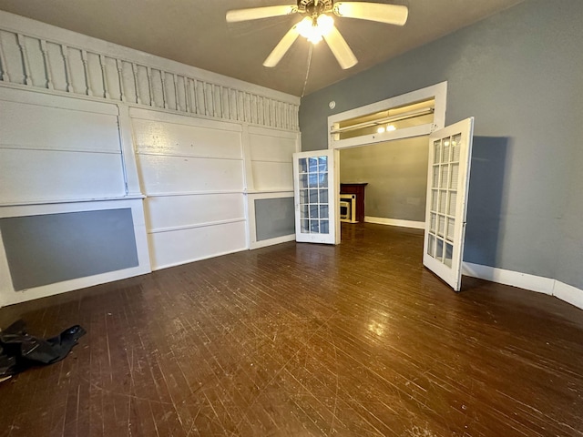 unfurnished living room with ceiling fan, dark wood-type flooring, and french doors