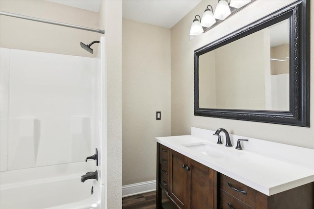 bathroom featuring hardwood / wood-style floors, vanity, and shower / bathtub combination