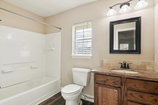 full bathroom featuring hardwood / wood-style floors, vanity, shower / bath combination, and toilet