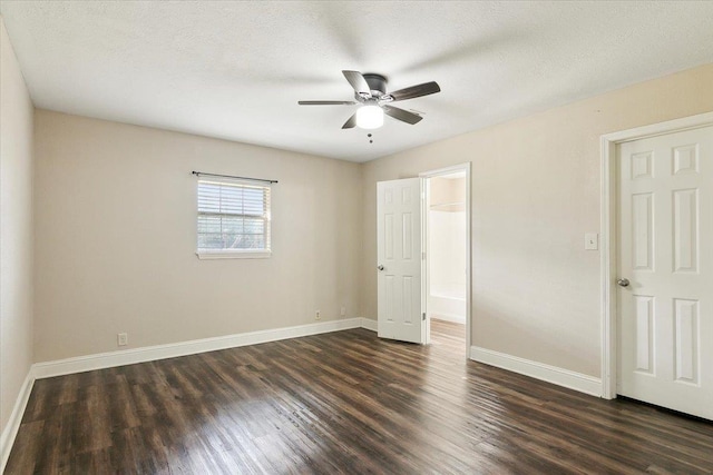 unfurnished bedroom featuring a textured ceiling, ceiling fan, and dark wood-type flooring