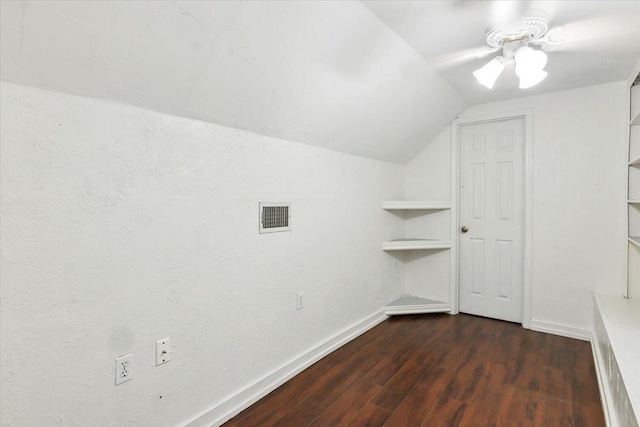 additional living space with vaulted ceiling and dark wood-type flooring