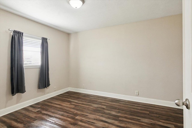 unfurnished room with dark hardwood / wood-style floors