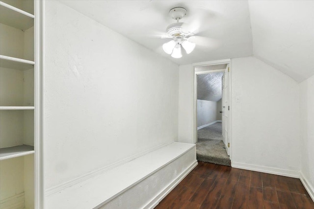 interior space featuring ceiling fan, dark wood-type flooring, and vaulted ceiling