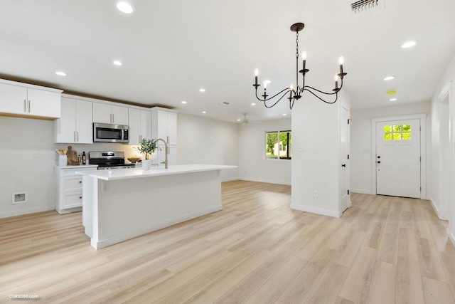 381 Perryman St, New Braunfels, TX 78130 - kitchen with appliances with stainless steel finishes, plenty of natural light, a notable chandelier, and visible vents