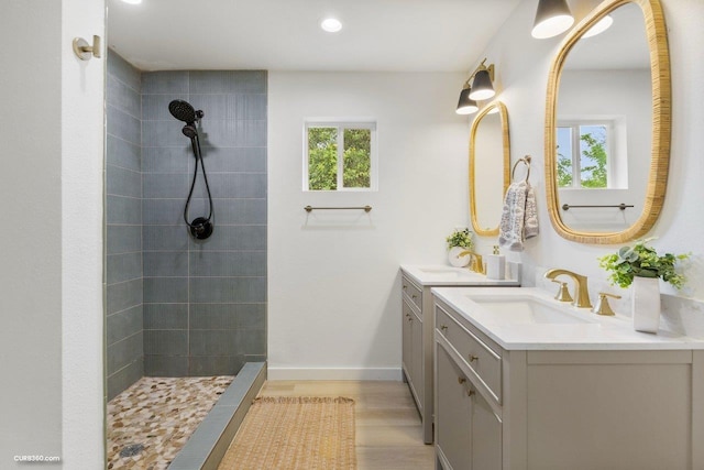 381 Perryman St, New Braunfels, TX 78130 - bathroom with a sink, a tile shower, recessed lighting, and two vanities