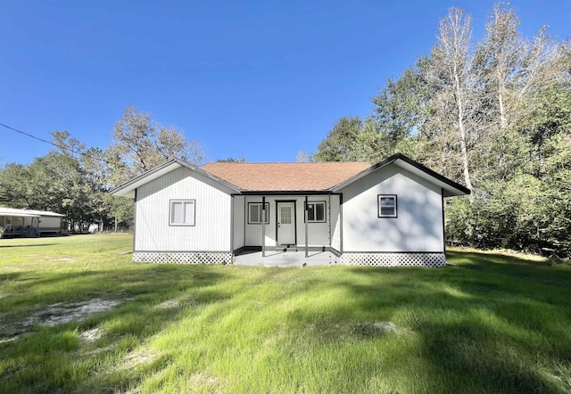 rear view of house featuring a yard