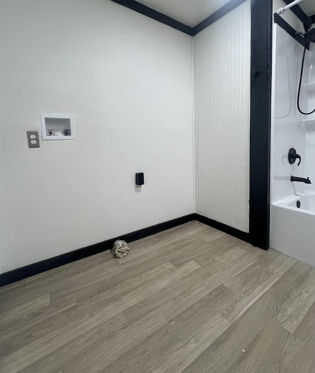 washroom featuring hookup for a washing machine and light wood-type flooring