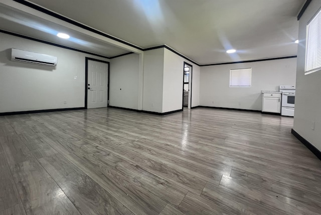 interior space with a wall mounted air conditioner, light wood-type flooring, and crown molding