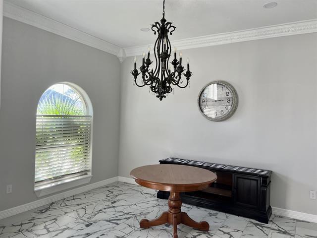7600 Oakmont Dr, Port Arthur, TX 77642 - office area featuring light marble finish flooring, a chandelier, ornamental molding, and baseboards