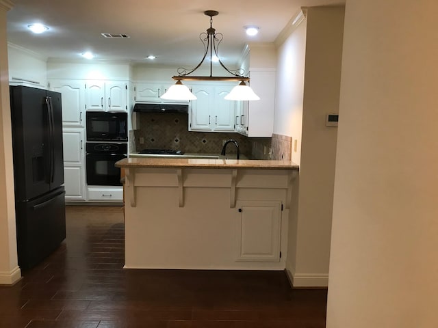 12 Encore Cir, Orange, TX 77630 - kitchen with a peninsula, ornamental molding, white cabinetry, and black appliances