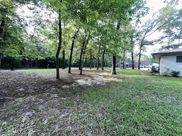 102 Ash Ln, Village Mills, TX 77663 - view of yard featuring central AC