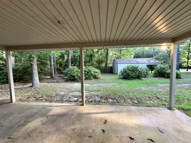 102 Ash Ln, Village Mills, TX 77663 - view of patio / terrace featuring a storage unit and an outbuilding