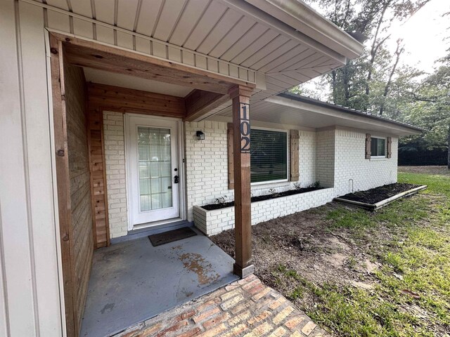 102 Ash Ln, Village Mills, TX 77663 - view of exterior entry featuring brick siding