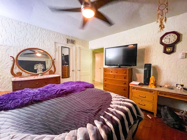 3832 W Park Ave, Orange, TX 77630 - bedroom featuring a textured wall, a textured ceiling, and a ceiling fan