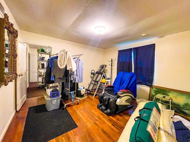 3832 W Park Ave, Orange, TX 77630 - workout room featuring wood finished floors and a textured ceiling
