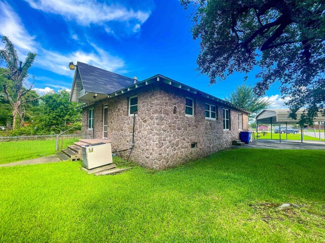 3832 W Park Ave, Orange, TX 77630 - view of side of home featuring a carport and stone siding