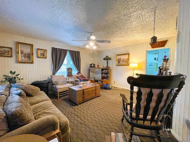 3832 W Park Ave, Orange, TX 77630 - carpeted living area with a textured ceiling, a ceiling fan, and wooden walls