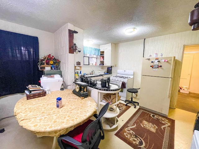 3832 W Park Ave, Orange, TX 77630 - kitchen featuring white appliances and a textured ceiling