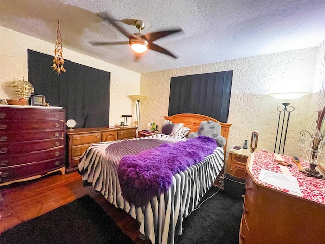 3832 W Park Ave, Orange, TX 77630 - bedroom featuring a textured wall, a textured ceiling, ceiling fan, and wood finished floors