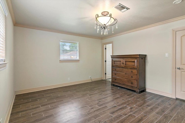 unfurnished bedroom featuring crown molding and a chandelier