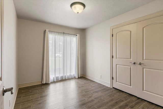 empty room featuring dark hardwood / wood-style flooring