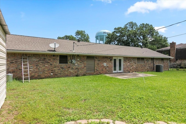 rear view of house featuring a yard, a patio, and central AC unit