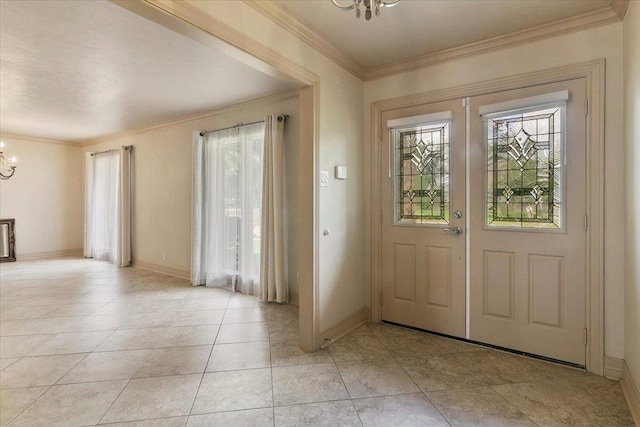 foyer entrance featuring crown molding, light tile patterned floors, and a chandelier