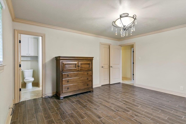 unfurnished bedroom featuring ensuite bath, crown molding, a textured ceiling, and an inviting chandelier