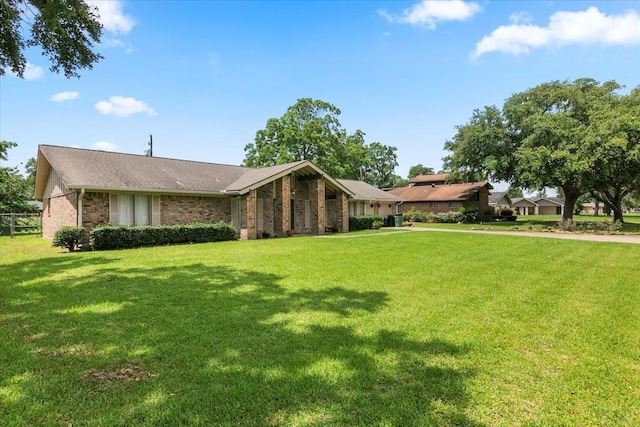 ranch-style home with a front lawn