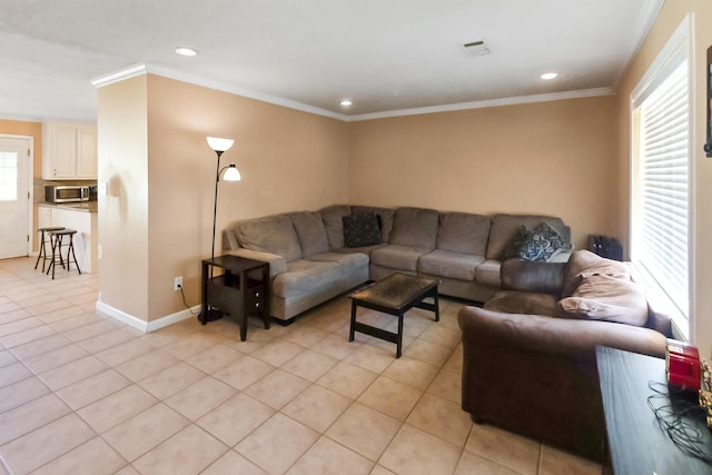 living room with crown molding, plenty of natural light, and light tile patterned floors