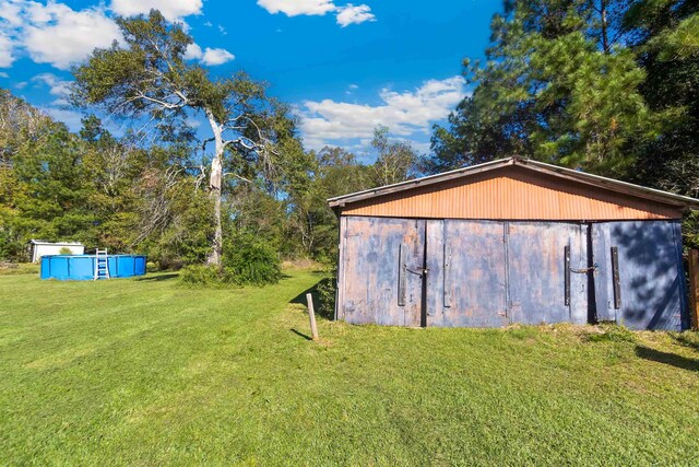 view of outdoor structure featuring a lawn