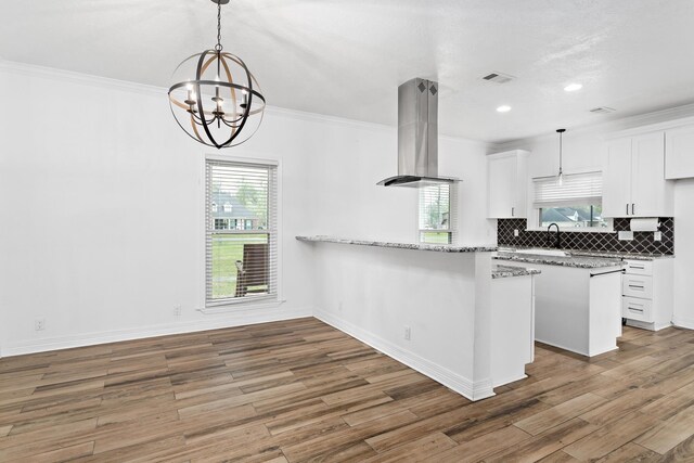 446 Piney Point Dr, Sour Lake, TX 77659 - kitchen featuring visible vents, ornamental molding, island exhaust hood, and decorative backsplash