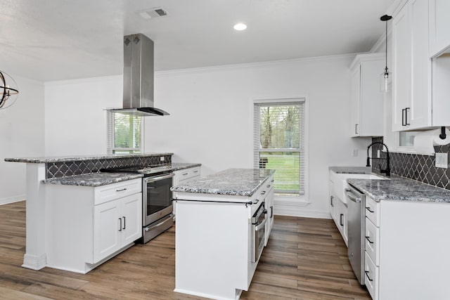 446 Piney Point Dr, Sour Lake, TX 77659 - kitchen featuring island exhaust hood, a sink, a kitchen island, appliances with stainless steel finishes, and light stone countertops