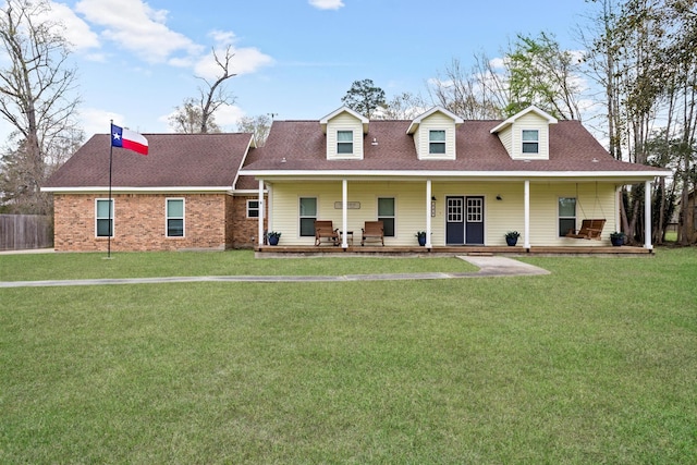 446 Piney Point Dr, Sour Lake, TX 77659 - cape cod house with brick siding, a porch, a front lawn, and roof with shingles