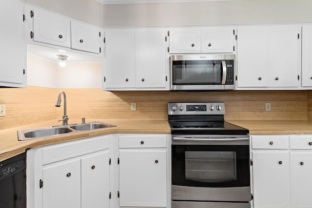 kitchen with backsplash, sink, white cabinets, and stainless steel appliances