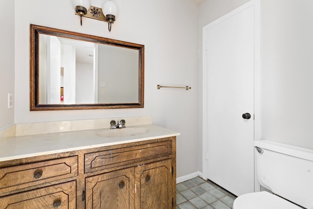 bathroom with tile patterned floors, vanity, and toilet