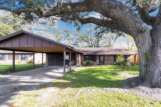 view of front facade with a carport and a front lawn