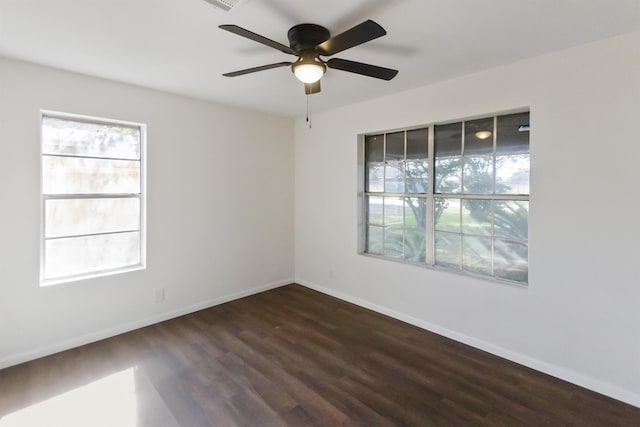 empty room featuring ceiling fan and dark wood-type flooring