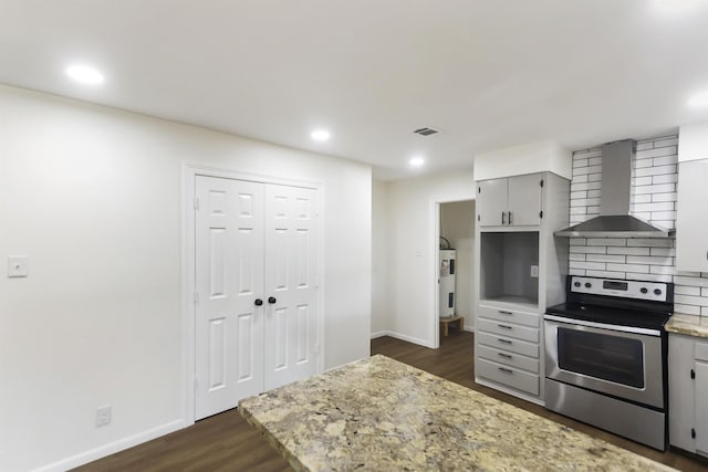 kitchen with decorative backsplash, dark wood-type flooring, wall chimney range hood, electric range, and gray cabinets