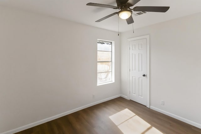 unfurnished room with ceiling fan and dark hardwood / wood-style flooring