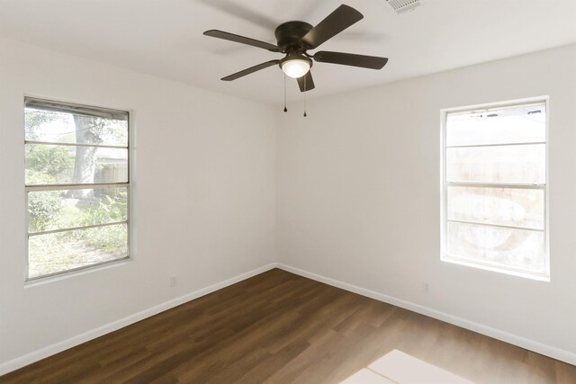 spare room featuring dark hardwood / wood-style floors and ceiling fan