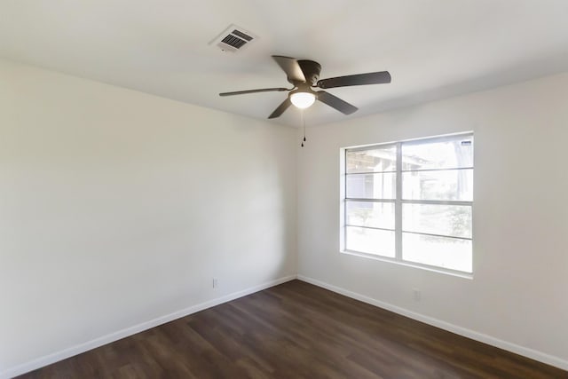 unfurnished room featuring ceiling fan and dark wood-type flooring