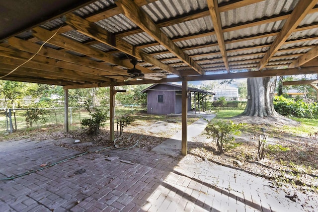 view of patio / terrace featuring ceiling fan and a shed