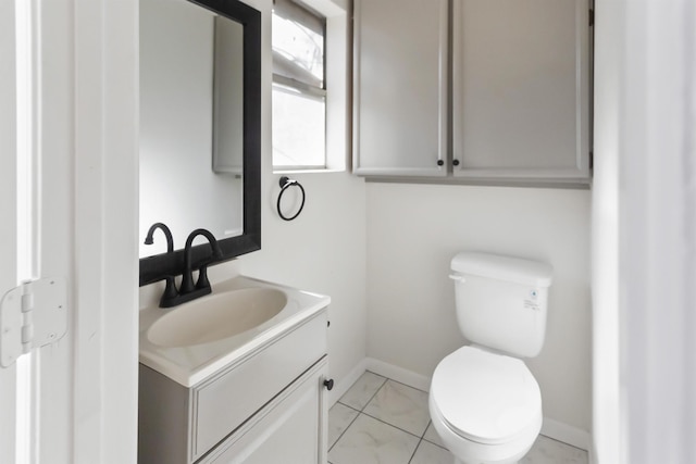 bathroom with tile patterned flooring, vanity, and toilet