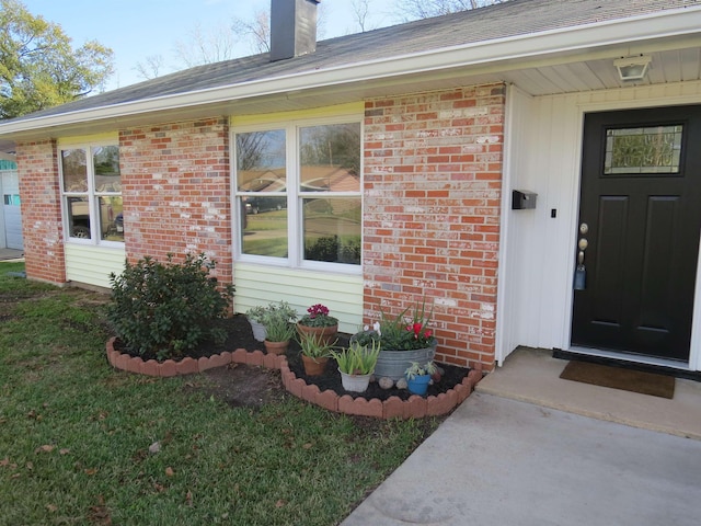 doorway to property featuring a lawn