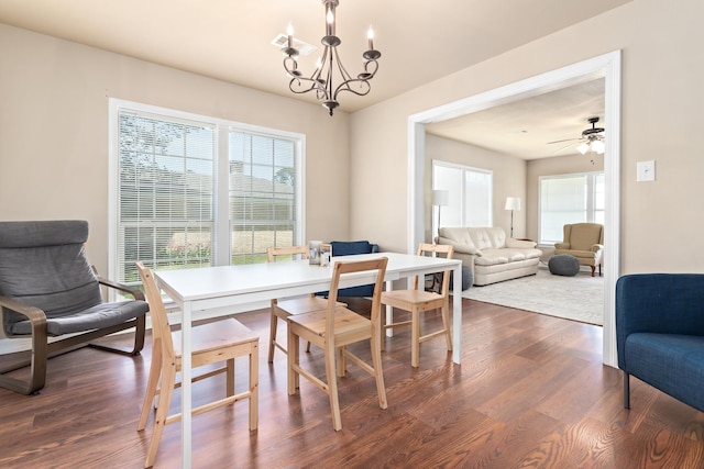 10775 Old Voth Rd, Beaumont, TX 77713 - dining room featuring dark wood-style floors, a chandelier, plenty of natural light, and a ceiling fan