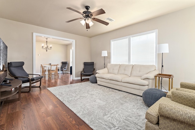 10775 Old Voth Rd, Beaumont, TX 77713 - living room with a chandelier, a ceiling fan, dark wood finished floors, and baseboards