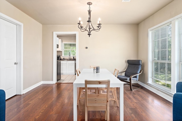 10775 Old Voth Rd, Beaumont, TX 77713 - dining room with a chandelier, baseboards, and dark wood-style flooring